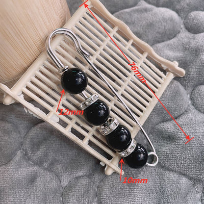 Broche imperdible con perlas y strass de fantasía
